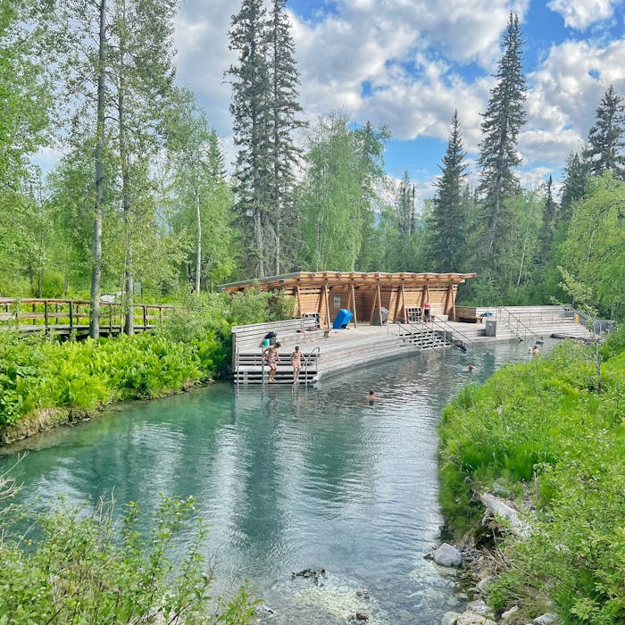 Family testing the water at Laird Hot Springs