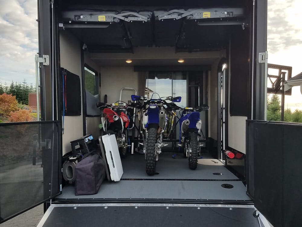 Dirt bikes in a toy hauler garage