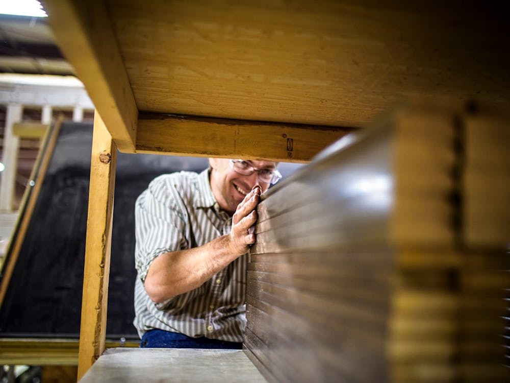man working in factory smiling