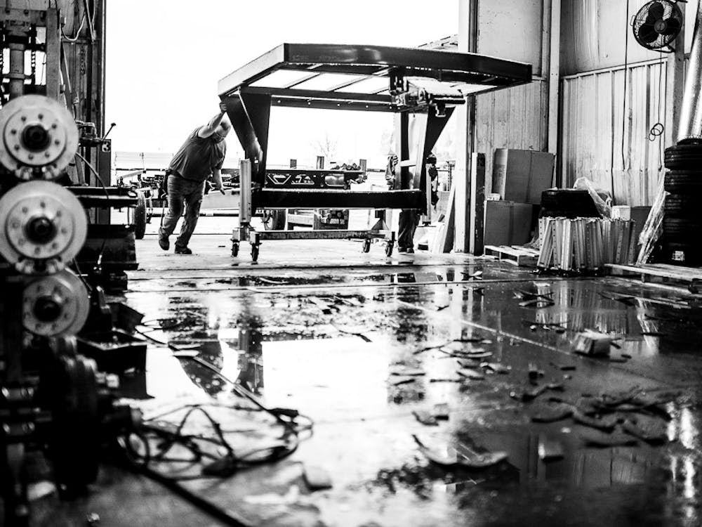 2 men working on the production line in an RV factory
