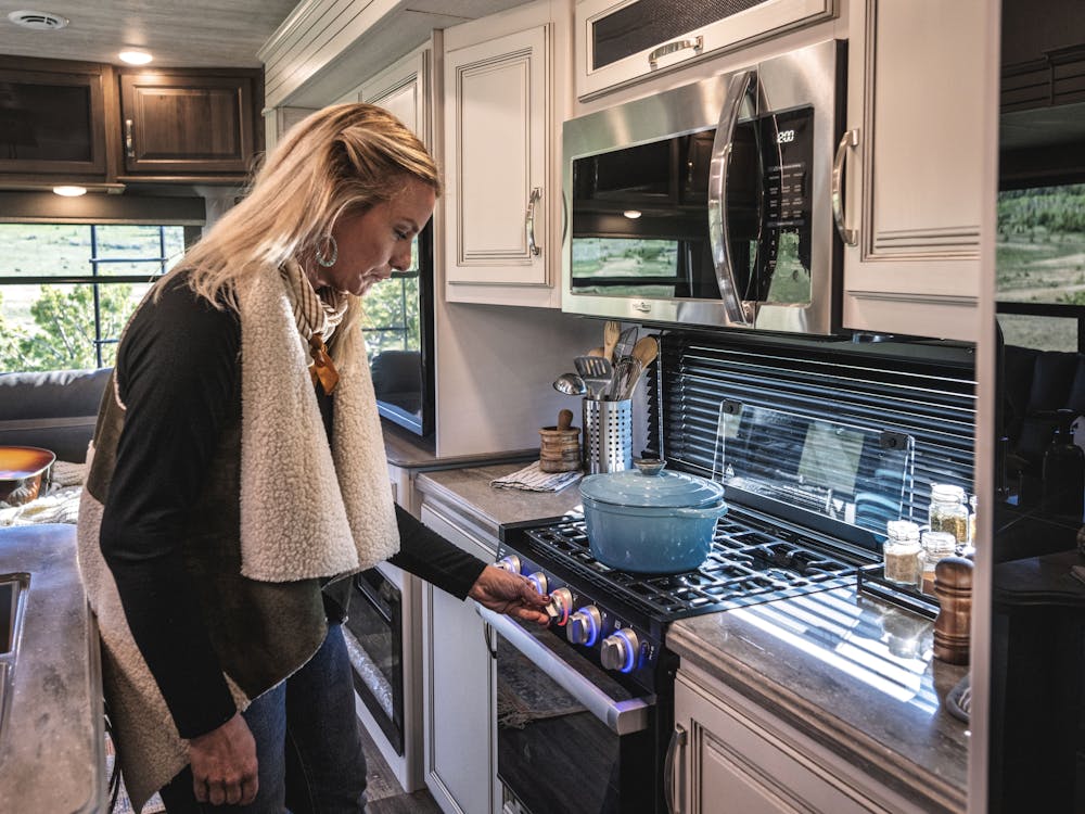 Lady cooking on stovetop in a Cougar