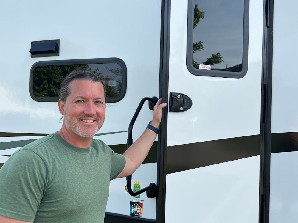 Owner showcasing the recently added accessory of RV Lock to the front door of Arcadia RV