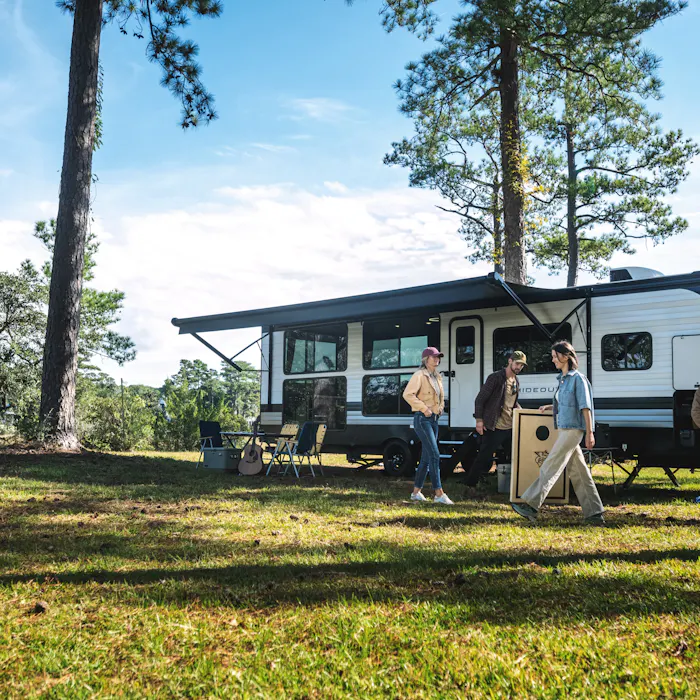 family setting up campsite